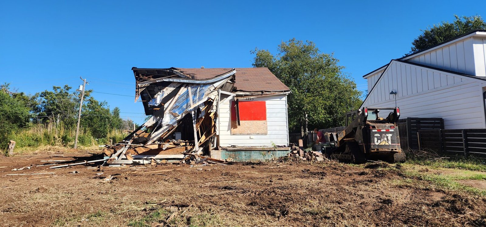 Demolition debris removal and site clearing in progress